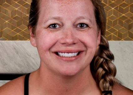 Happy patient at Xdentistry standing out her new smile